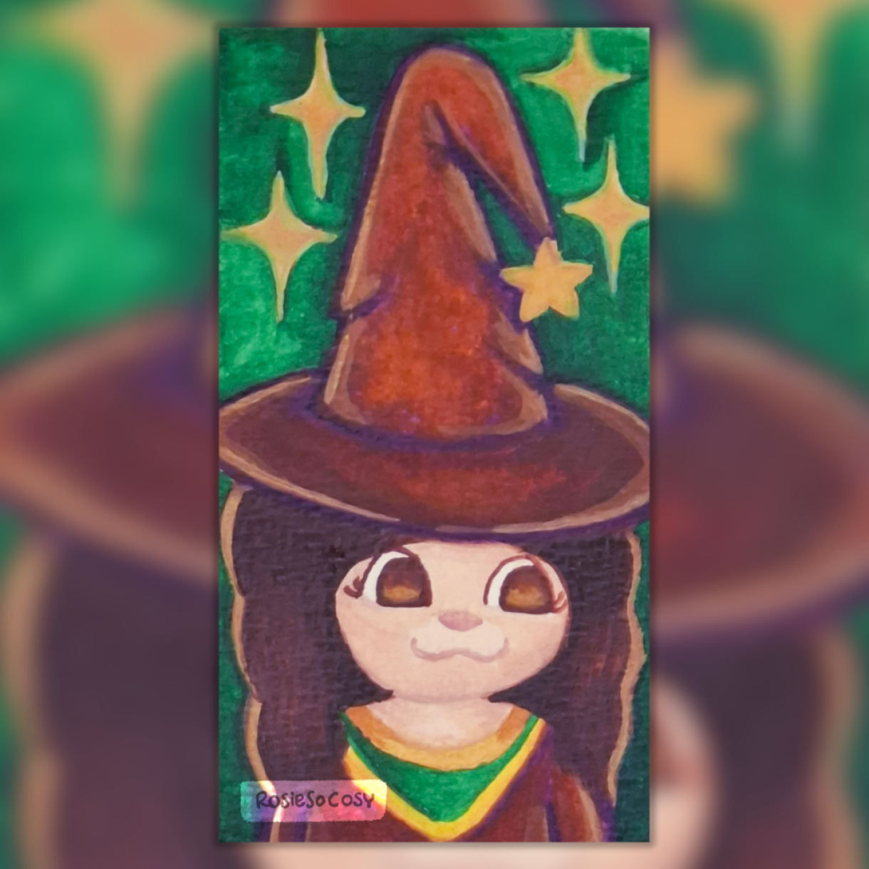 A watercolour painting of a cute little witch. She has fair skin, brown eyes and auburn hair. She is wearing a worn down witch’s hat and a witch gown in a purple brown colour. The background is green with golden yellow sparkles.
